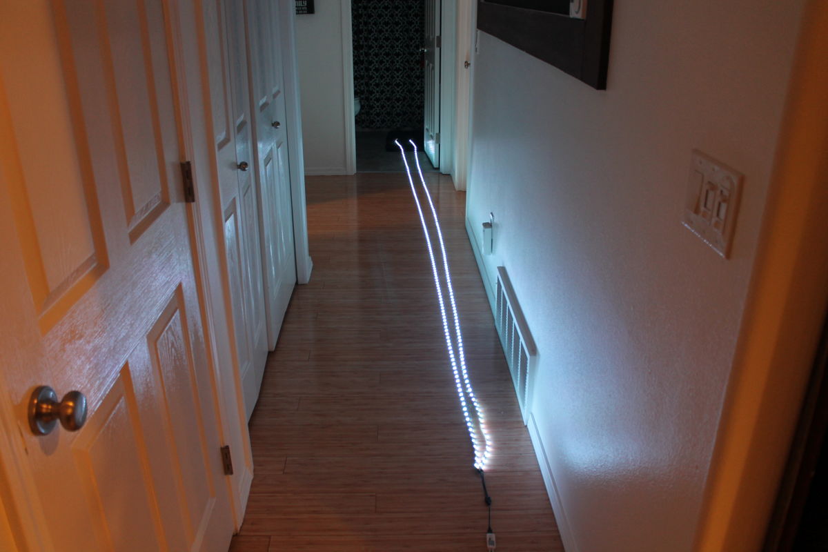 Laying out the LED strips to measure them in the hallway. 